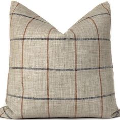 a tan and brown plaid pillow on a white background