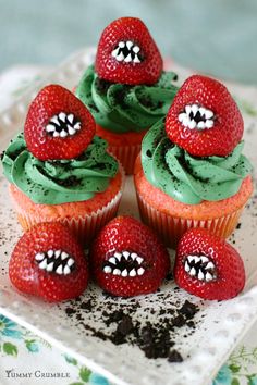 cupcakes with green frosting and strawberries decorated like monster's teeth