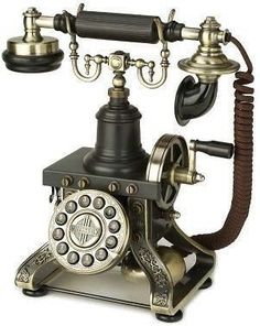 an old fashioned phone with two dials on the front and one on the back