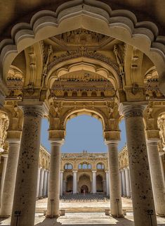 an archway in the middle of a building with columns and arches on both sides,