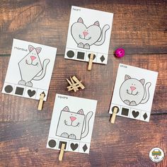 four cat match up cards with clothes pins on them, and two cats in the middle