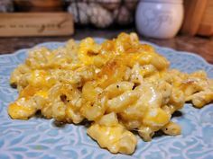 a blue plate topped with macaroni and cheese