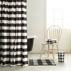 a black and white checkered shower curtain next to a chair