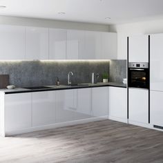 a modern kitchen with white cabinets and black counter tops is seen in this image from the front view