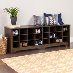 a living room with a couch, coffee table and vases on the floor in front of it