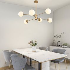 a dining room with marble table and chairs