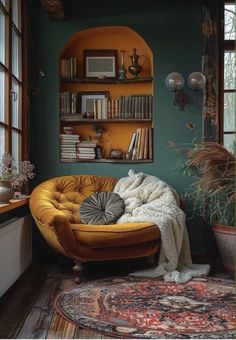 a living room filled with furniture and bookshelves next to a window covered in plants