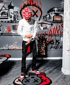 a young man standing on top of a skateboard