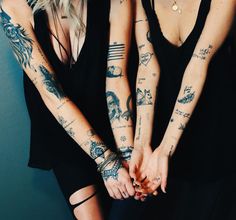 two beautiful women with tattoos on their arms