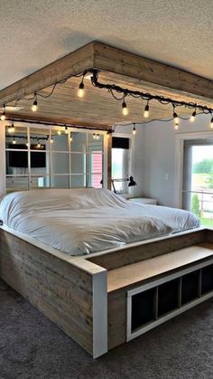 a bed with lights hanging from it's headboard and foot board in a bedroom