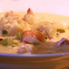 a white bowl filled with soup on top of a table