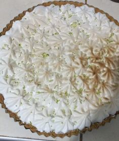 a pie sitting on top of a table covered in white frosting