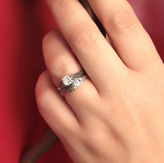 a close up of a person's hand with a ring