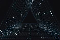 an image of a triangle in the middle of a dark room with lights on it