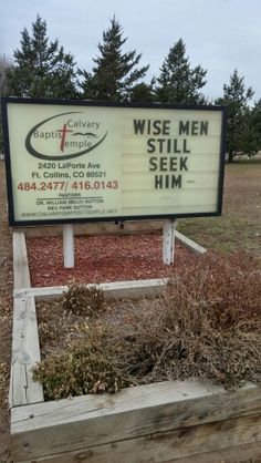 a sign for a church that says wise men still seek him in front of a field