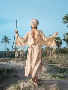 Natural Beige Boho dress I made from very beautiful natural beige cotton. It has fringee on the sleeves. Oversize cut make it comfy to wear and belt helps to make outfit elegant. The dress is open back and has a v-neck cut in front. This dress is super special in my collection. It's all about Love and Freedom. It's perfect for any occasion going out or flowing in it at home. You can wear it super free or with the belt. Being inspired by the grace, power, wisdom, elegance of white eagle, once in Bohemian Linen Boho Dress For Beach, Bohemian Style Linen Boho Dress For Beach, Bohemian Style Linen Boho Beach Dress, Bohemian Linen Boho Beach Dress, Beige Festival Dress With Tassels, Bohemian Beige Dresses With Tassels, Beige Tassel Dress For Festival, Festival Beige Dresses With Tassels, Bohemian Cotton Dress With Frayed Hem