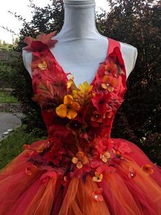 an orange and red dress with flowers on it