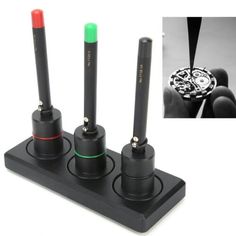 three different types of electronic devices on a black stand with red, green and blue knobs