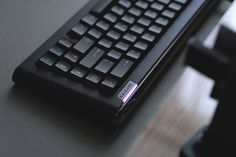 a black keyboard sitting on top of a table