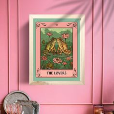 a pink wall with a frog on it and the words'the lovers'in front