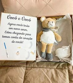 a stuffed teddy bear in a box with spanish writing on the front and back side