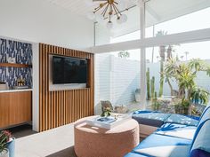 a living room filled with furniture and a flat screen tv on top of a wall