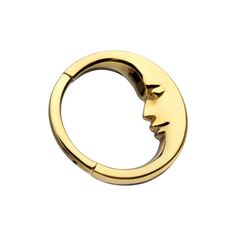 a gold plated ring with two faces in the middle and one face on it's side