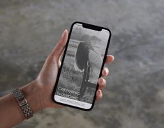 a person holding an iphone in their left hand and taking a photo on the screen