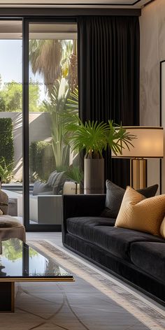 a living room filled with furniture and a large glass table in front of a window