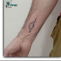 a man's arm with a small tattoo on it