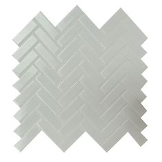 a white tile pattern on the wall with an angled diagonal design in grey and white