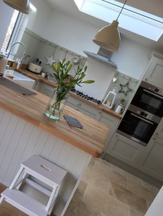 a kitchen with an island and skylight above it