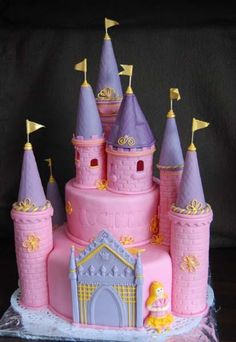 a pink princess castle cake with purple turrets