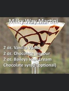 a martini glass with chocolate swirl toppings on it and the words milky - way martini