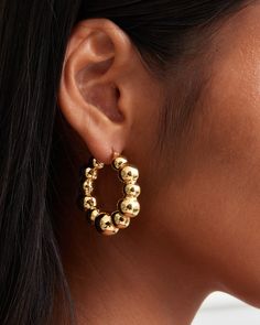 An organic shaped chunky hoop designs that is constructed with uneven sized bubbles. The volume on the earrings is big but the weight on the earrings is controlled by our Italian electroforming production technique to maximize comfort. The hoops are made in sterling silver metal plated in 18K yellow gold or white gold. The earrings are all hand polished and quality inspected to assure a luxury finish. Closure: Hoop Stamp Approx. Measurement: Outer Length: 1.45 inches Outer Width: 45 inches Silve Modern Chunky Round Earrings, Luxury Brass Hoop Earrings As Statement Piece, Chunky Small Hoop Metal Earrings, Luxury Pierced Brass Hoop Earrings, Luxury Statement Hoop Earrings With Gold-tone Hardware, Gold Plated Hoop Earrings With Gold-tone Hardware, Gold-tone Polished Metal Hoop Earrings, Earring Sale, Shop Earrings