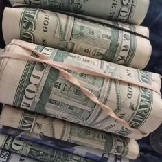 stacks of rolled up dollar bills tied together