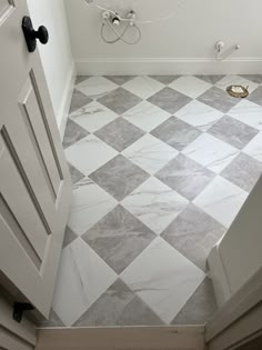 a bathroom with white and gray tile flooring