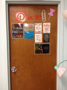 the front door is decorated with pictures and magnets for pin it up on wood paneling