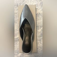 Marc Fisher Leather Slip On Shoes. Unworn Silver Casual Slip-on Heels, Silver Leather Flat Heel Mules, Silver Leather Mules With Flat Heel, Flat Silver Leather Mules, Casual Leather Flats For Party, Flat Leather Mules For Party, Flat Leather Party Mules, Leather Slip On Shoes, Marc Fisher