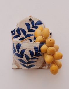 a blue and white bowl filled with yellow fruit