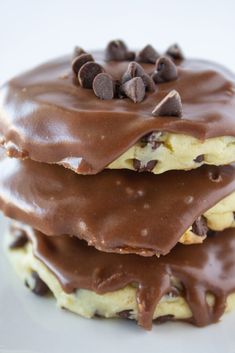 three chocolate covered cookies stacked on top of each other