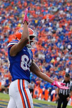 a football player holding his hand up in the air