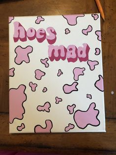 a pink and white canvas with the words hey mad on it next to a pair of pencils