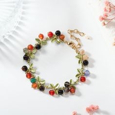 Wrap your wrist in the vibrant hues of nature with our Multi Berry Bracelet. This delightful accessory features an assortment of berry-inspired beads, creating a playful and colorful ensemble. Whether you're looking to add a touch of freshness to your everyday wear or complement a festive outfit, this bracelet is a versatile and charming choice. Embrace the sweetness of nature with the Multi Berry Bracelet, a lively addition to your jewelry collection. DETAILS Plating: 18K Gold Materials:   18K Gift Multicolor Polished Beads Crystal Bracelet, Multicolor Polished Beads Crystal Bracelet For Gift, Elegant Colorful Bracelets For Gifts, Adjustable Multicolor Nature-inspired Jewelry, Elegant Multicolor Flower Beaded Bracelets, Multicolor Charm Bracelet With Natural Round Beads, Multicolor Charm Bracelet With Natural Stones And Round Beads, Multicolor Beads Charm Bracelet Gift, Multicolor Charm Bracelet With Natural Stone Round Beads