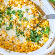 a white bowl filled with corn and cheese