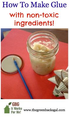 a jar filled with candy sitting on top of a red table next to a spoon