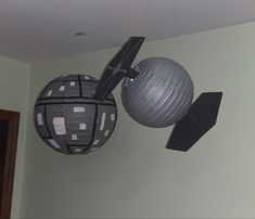 two paper balls are hanging from the ceiling