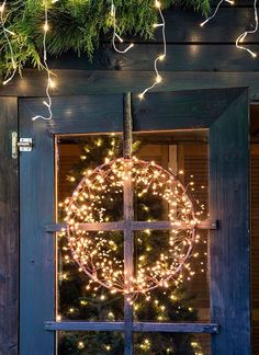 a christmas wreath is hanging on the window sill