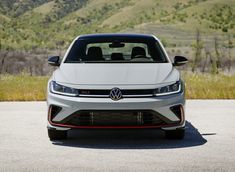 the front end of a white volkswagen car