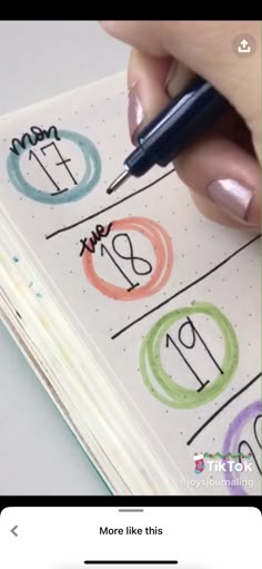 someone is writing numbers on a notebook